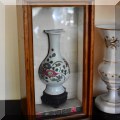 P11. Porcelain vase in shadow box. 